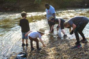 volunteers pick up trash from the creek